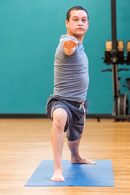 bene-warrior-two Bene, founder of Yoganomics in Warrior Two pose at Hurst Texas Rec Center